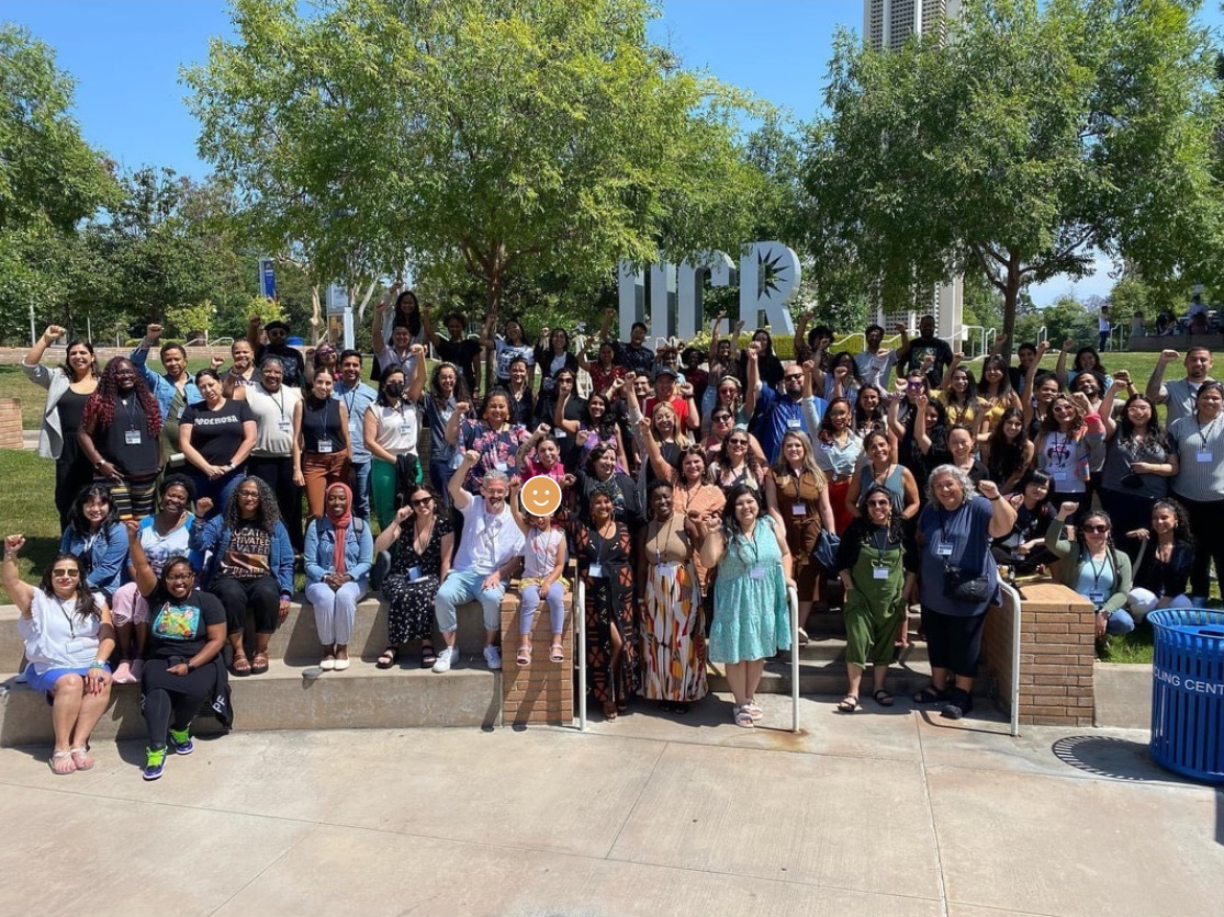 ITOC 2026 fellows gathered in front of the UCR sign with raised fists